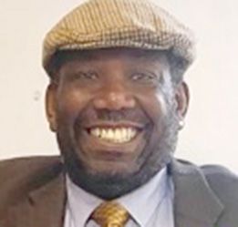 Smiling man wearing a flat cap